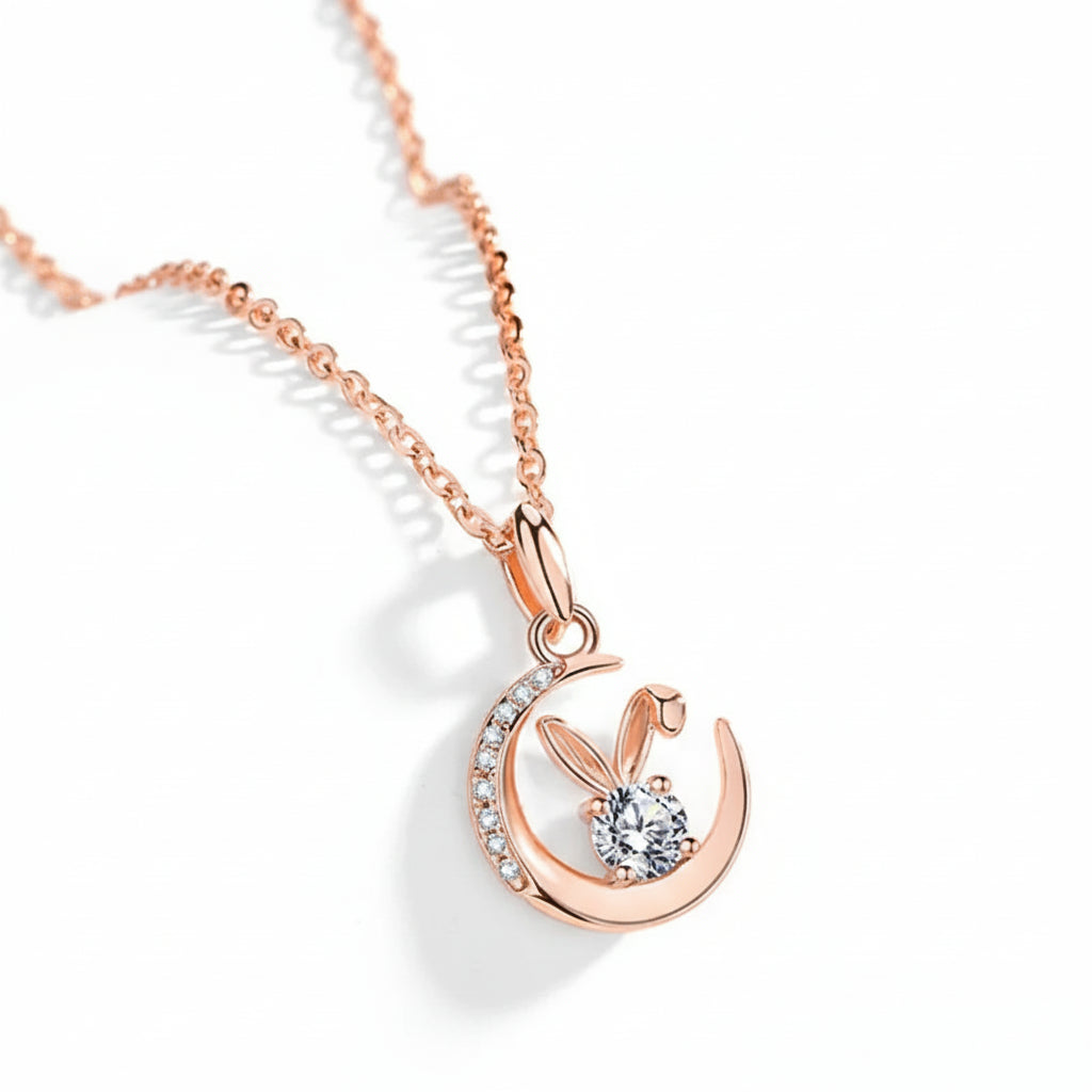 Rose gold necklace with a bunny pendant on a soft pink background