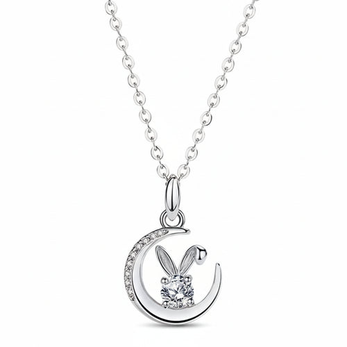 Silver necklace with a bunny and moon pendant on a soft pink background